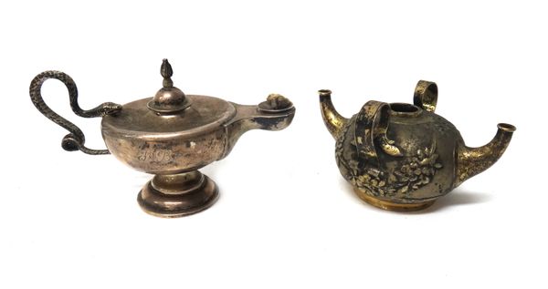 A late Victorian silver table lighter, modelled as a Roman oil lamp, the handle formed as a coiled snake, the detachable cover with flame finial, Lond