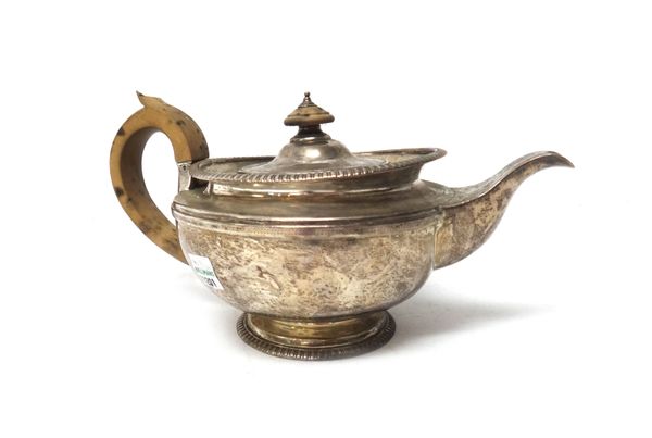 A William IV silver teapot, of compressed circular form, with gadrooned borders within a plain body, and wooden handle (damaged), London, 1834, weight