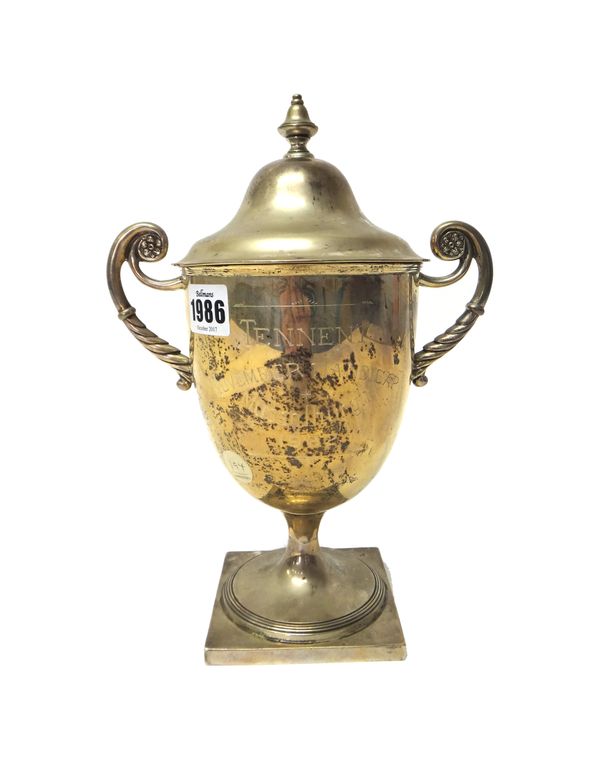 A late Victorian Scottish silver twin handled trophy cup and cover, of urn form, domed cover and baluster finial, the body later presentation engraved