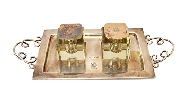 A late Victorian silver twin handled twin bottle inkstand, the rectangular stand with wirework handles, raised on four spherical feet, London 1898, we