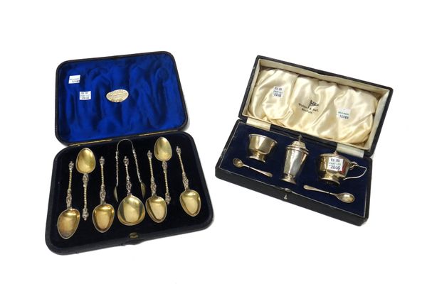 A set of six Victorian silver gilt apostle teaspoons, with a matching pair of sugar tongs and caddy spoon, London 1867, with a fitted case and a silve