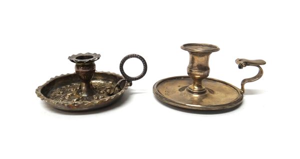 A Victorian silver chamber candlestick, with floral and scroll embossed decoration and with a loop shaped handle, London 1887 and another silver chamb