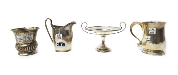 Silver, comprising; a helmet shaped milk jug, having a reeded rim, Chester 1931, a christening mug, London 1923, a twin handled bonbon dish, Sheffield