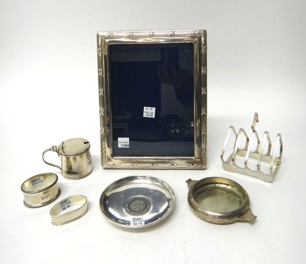 Silver and silver mounted wares, comprising; a rectangular photograph frame, a five bar toastrack, of angular form, by Elkington & Co, Birmingham 1947