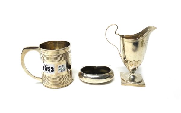 Silver, comprising; a George III mug, decorated with reeded bands, London 1811, a George III helmet shaped cream jug, with semi spiral fluted decorati