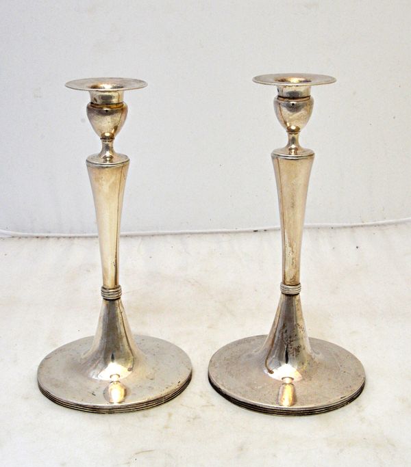 A pair of Austrian table candlesticks, each with a plain tapering stem, raised on a trumpet shaped foot, having a reeded rim, height 21cm, makers mark