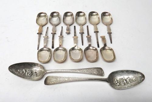 Silver table flatware, comprising; two later decorated dessert serving spoons, embossed and engraved with floral sprays, London 1802 and 1794 and elev