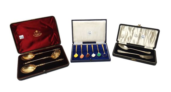 A Victorian silver gilt dessert set, comprising; a pair of spoons and a sugar sifting spoon, each having a spiral stem, with a figure terminal, London