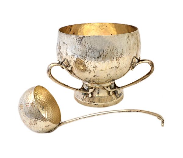 An Irish silver punch bowl, of circular three handled design, in the Art Nouveau taste, the body with martele decoration and raised on a circular foot