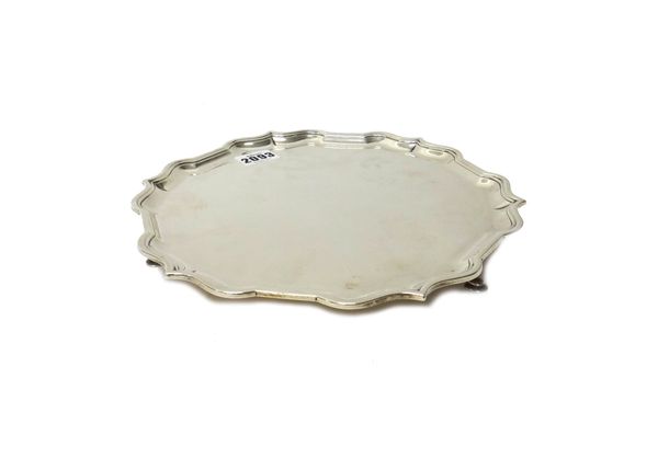 A Britannia Standard silver salver, of shaped circular form, having a pie-crust rim, raised on three pad feet, in the 18th century taste, diameter 25.