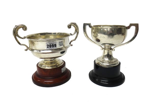 A silver twin handled trophy cup, on a circular foot, Birmingham 1937, with a wooden stand and another silver twin handled trophy cup, on a circular f