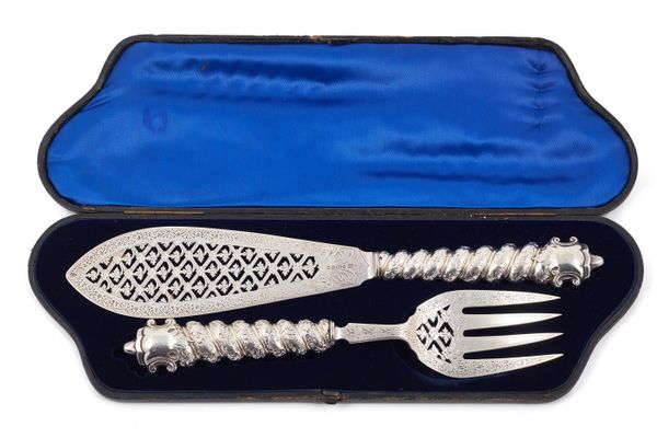 A pair of Victorian silver fish servers, with pierced and engraved decoration, the spiral loaded handles with foliate decoration, Sheffield 1866, with