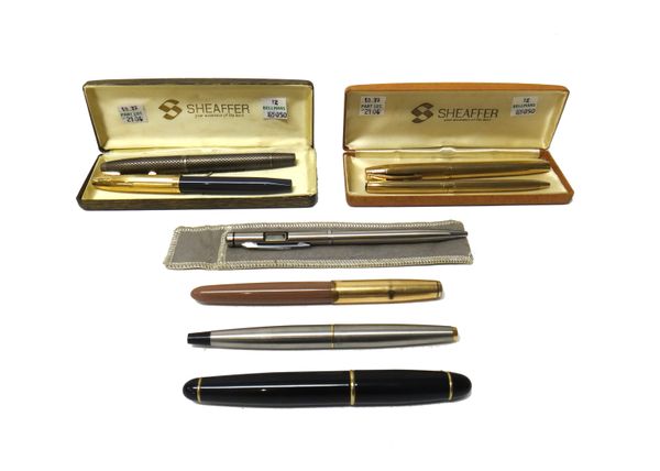 A Sheaffer U.S.A Sterling silver fountain pen, with cross hatched decoration, a Sheaffer gilt metal and blue plastic fountain pen, a Sheaffer gilt met