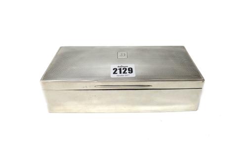 A silver rectangular large table cigarette box, wooden lined within, the hinged lid engine turned, Birmingham 1925.