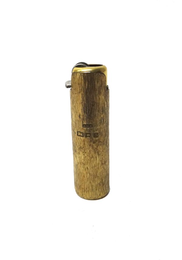 A silver gilt lighter sleeve by Gerald Benney, London, of cylindical form, with bark textured decoration, length 7.2cm, weight 40.5gms.