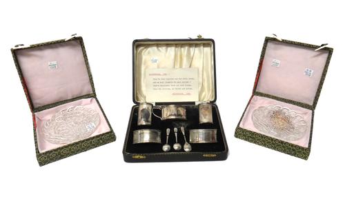 A silver five piece condiment set, comprising; a mustard pot, a pair of pepperettes and a pair of salts, with a pair of salt spoons and a mustard spoo