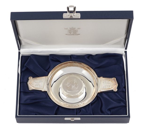 A silver twin handled quaich shaped dish, the centre with the conjoined portraits of Queen Elizabeth I and Queen Elizabeth II, by Christopher Lawrence