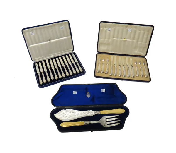 A matched set of six silver bladed dessert/fruit knives, the blades and the loaded pistol grip handles London 1910 and six silver pronged dessert/frui