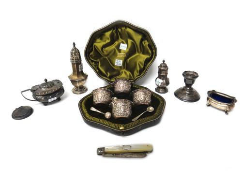 Silver and silver mounted wares, comprising; a set of four salts, each of shaped circular form, having scroll embossed decoration, London 1901, with t
