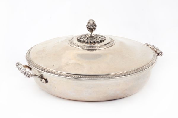 A European twin handled lidded tureen and cover, of circular form, with cast handles, the detachable cover with a bud finial and with decorated border