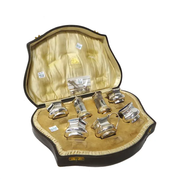 A silver seven piece condiment set, comprising; four salts, a pair of pepperettes and a mustard pot, each piece of hexagonal bombe form, Birmingham 19