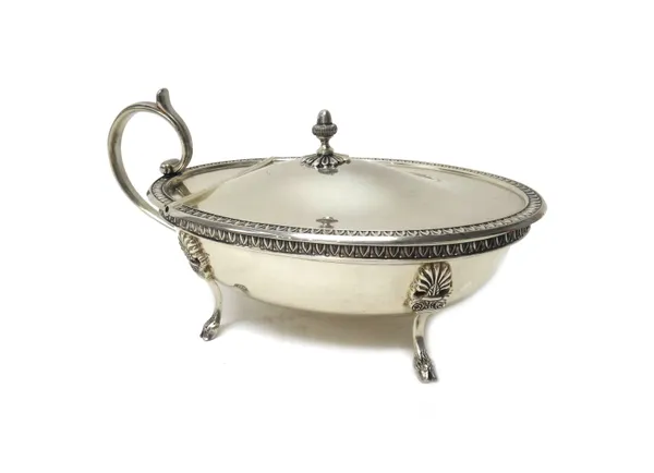 An Italian hinge lidded oval sauce tureen, the hinged lid with a stylized acorn finial, decorated rim, scrolled handle and raised on four classical ho