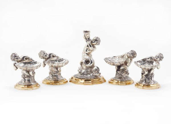 A set of four figural salts, each designed as a putto holding a scallop shell, detailed 800, raised on gilt metal shaped bases, height 9cm and a centr