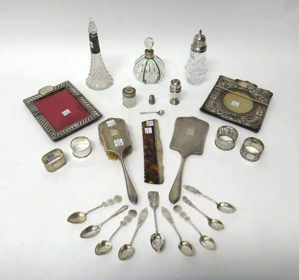 Silver and silver mounted wares, comprising; two photograph frames, a faceted glass sugar caster, two scent bottles, a smelling salts bottle, a pepper