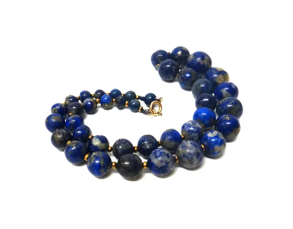 A single row necklace of graduated lapis lazuli beads, on a gilt metal boltring clasp, length 46cm.