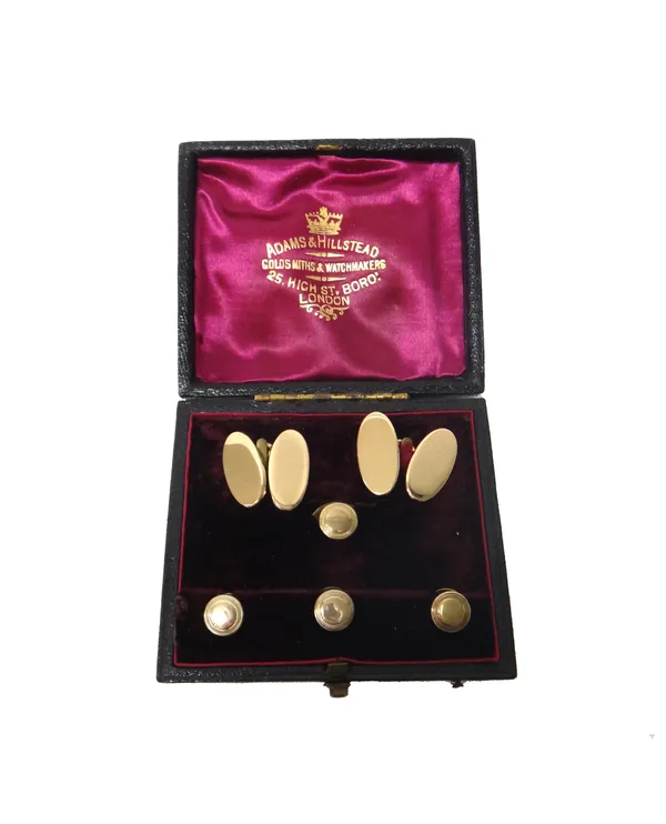A pair of gold cufflinks, with plain oval backs and fronts, detailed 15 CT, combined weight 12.5 gms and a set of three small and one larger dress stu