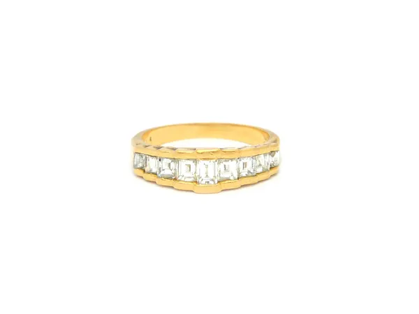 An 18ct gold and diamond nine stone half hoop ring, mounted with a row of millennium cut diamonds, graduating in size to the centre stone, Birmingham