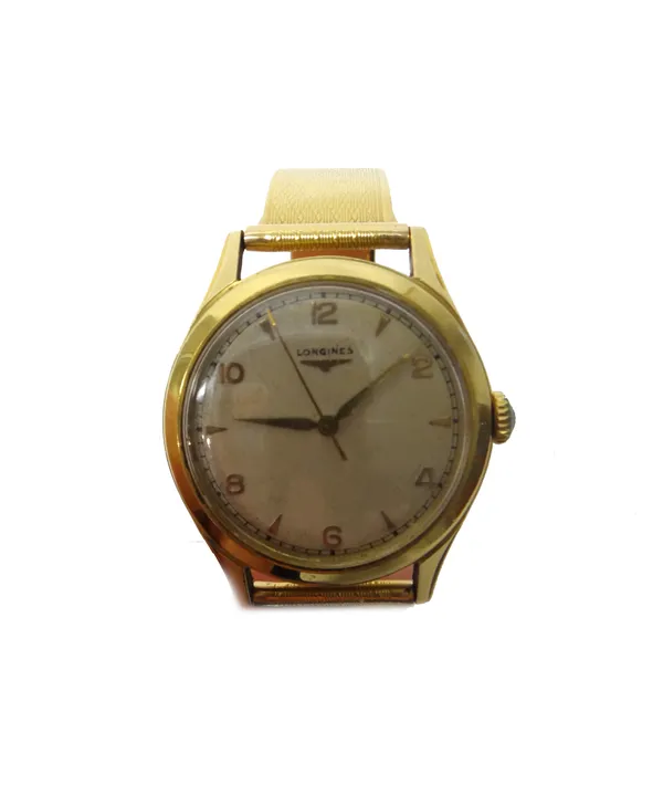 A Longines gold circular cased gentleman's wristwatch, the signed silvered dial with alternating gilt Arabic and arrow shaped numerals, gilt hands and