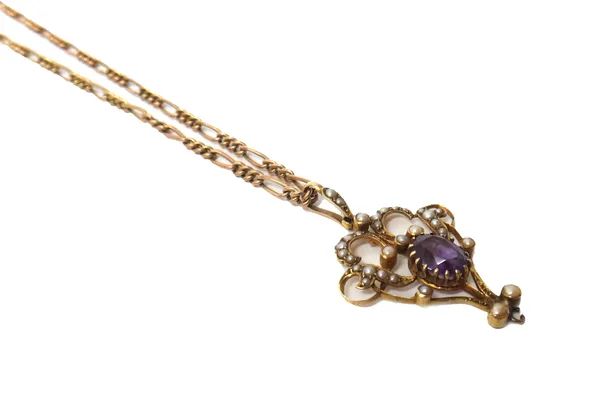 An Edwardian gold, amethyst and seed pearl set pendant, in a scroll pierced openwork design, claw set with the oval cut amethyst at the centre (the dr