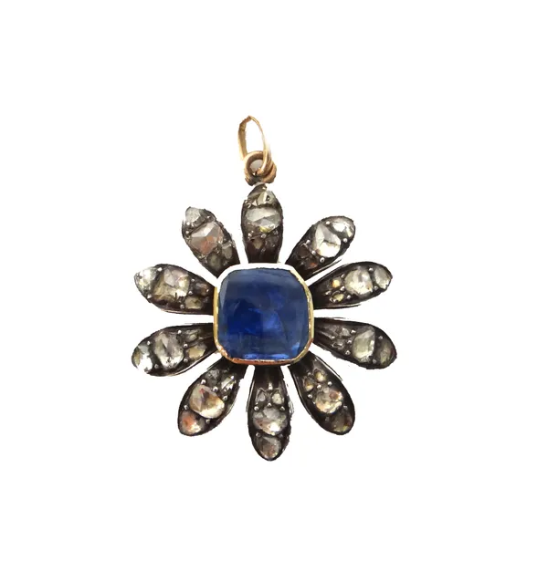 A rose diamond and foil backed sapphire set pendant, designed as a flowerhead, mounted with a flat native cut foil backed sapphire at the centre, with