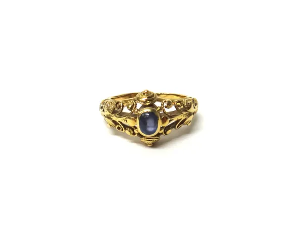 A gold and cabochon sapphire single stone ring, in a scrolled wirework abstract design, mounted with an oval cabochon sapphire, unmarked, ring size L