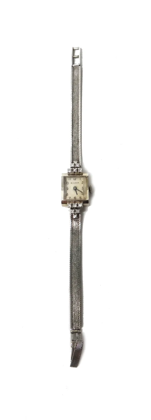 A Bulova lady's white gold and diamond set dress wristwatch, the signed rectangular silvered dial, with black Arabic numerals, the case terminals moun