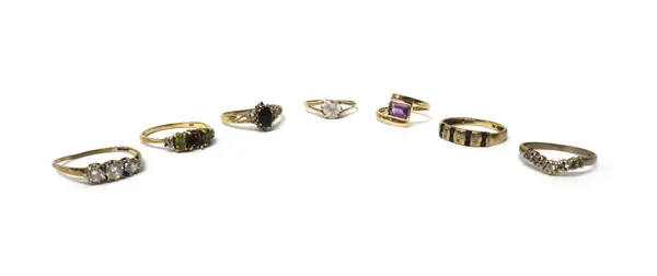 A 9ct gold ring, mounted with a rectangular cut amethyst, in a crossover design, a 9ct gold, sapphire and diamond set ring and five further mostly 9ct