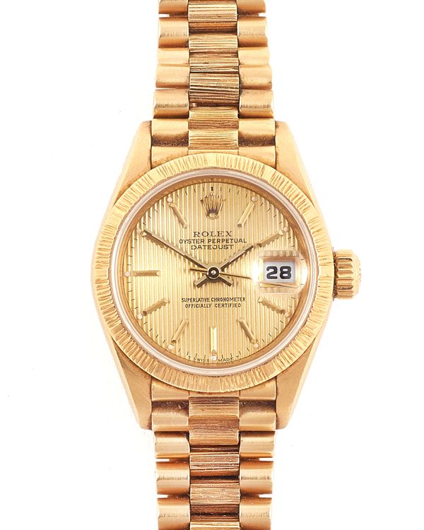 A Rolex Oyster Perpetual Datejust lady's 18ct gold bracelet wristwatch, the signed circular gilt dial with gilt baton shaped numerals, gilt hands, cen