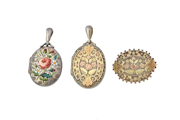 A Victorian silver and enamelled oval pendant locket, the front enamelled with floral motifs, Chester 1882, a Victorian silver and two colour gilt ova