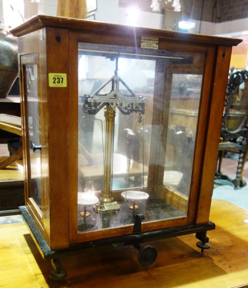 A set of early 20th century mahogany cased chemist's scales.   J5