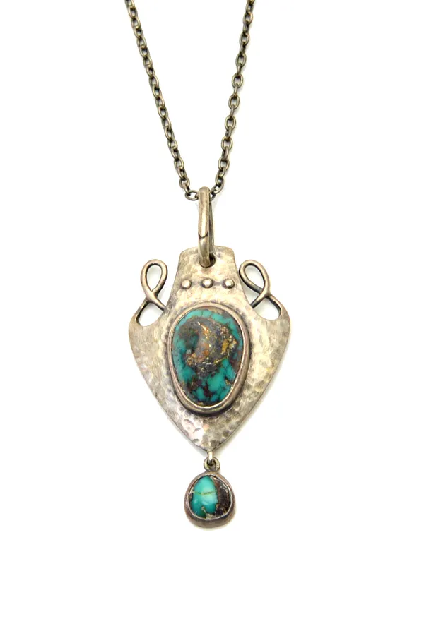 A silver and turquoise matrix Art Nouveau pendant, by Murrle Bennett & Co, of panel shaped form, with a beaded and wirework surmount, mounted with the