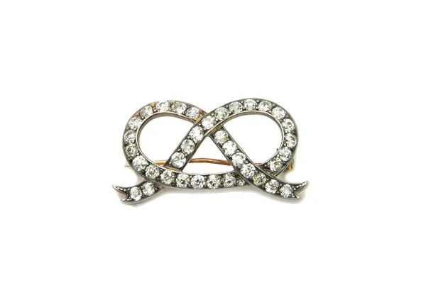 A gold backed and silver fronted, diamond set brooch, designed as a Staffordshire knot, mounted with cushion shaped diamonds, probably last quarter of