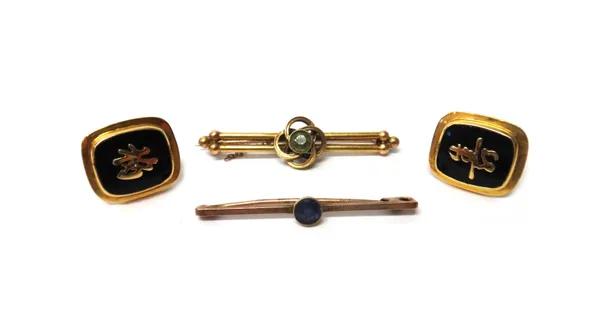 A pair of gold mounted, black onyx cufflinks, the fronts with Oriental character motifs and with folding bar fittings at the backs, detailed 14 K W.K,