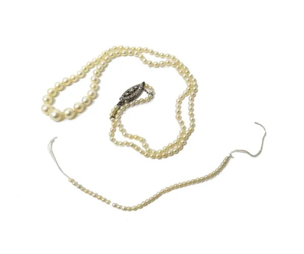 A single row necklace of untested pearls, graduating in size to the front, on a diamond set marquise shaped openwork clasp and an additional length of