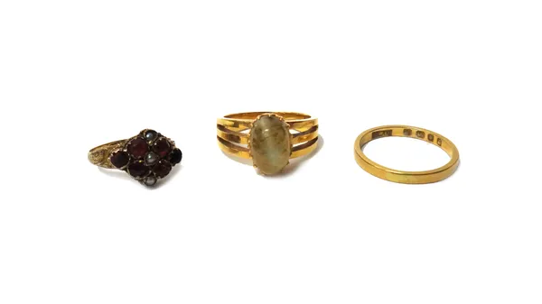 A gold ring mounted with an oval chrysoberyl cat's eye, ring size J and a half, a 9ct gold, seed pearl and red gem set cluster ring (one red gem lacki