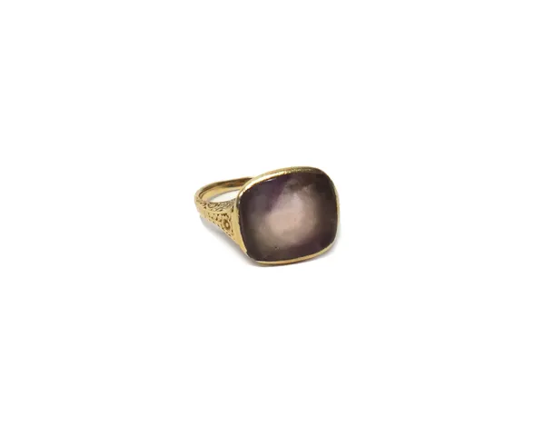 A gold ring mounted with a cushion shaped pale amethyst, the shoulders with floral engraved decoration, possibly last quarter of the 19th century, rin