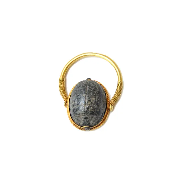 An Egyptian gold and carved scarab ring, the rotating bezel with hieroglyphs to the underside of the scarab top, otherwise with ropetwist wirework dec