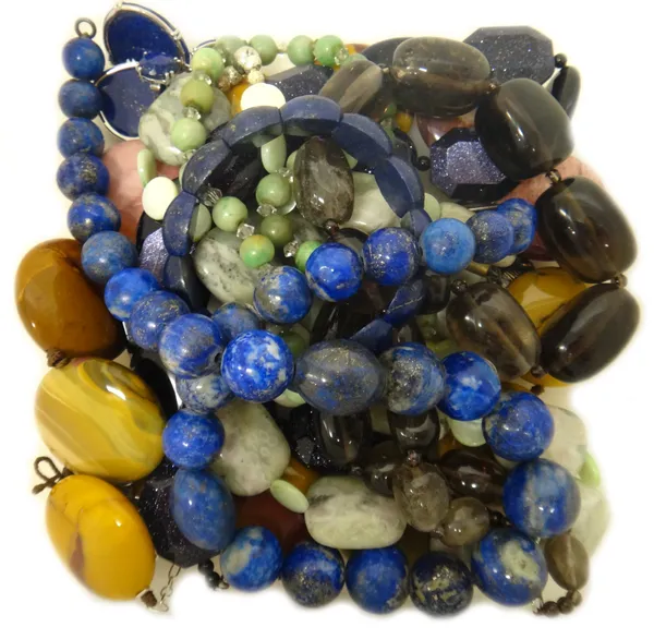 A single row necklace of lapis lazuli beads, a lapis lazuli bracelet, a pair of reconstituted lapis lazuli earrings, a graduated smoky quartz bead nec