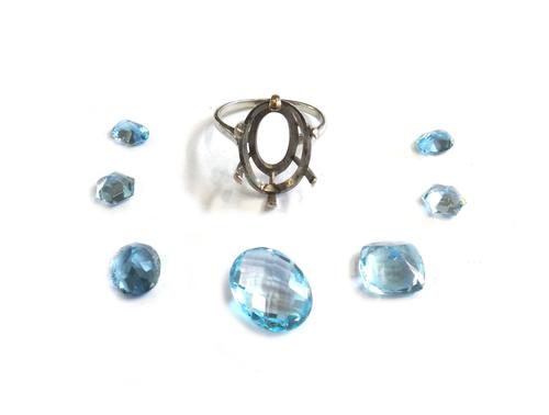 A white gold ring mount, with six claws to support a gemstone, ring size O, gross weight 2.8 gms, and seven variously cut loose aquamarines, (8).