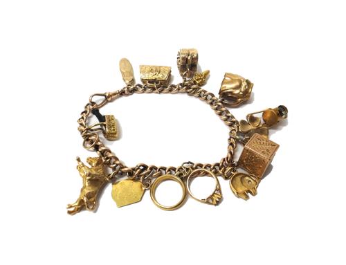 A gold hollow curb link charm bracelet, with a gold swivel clasp, detailed 9 C, fitted with thirteen mostly 9ct gold pendants and charms, including an